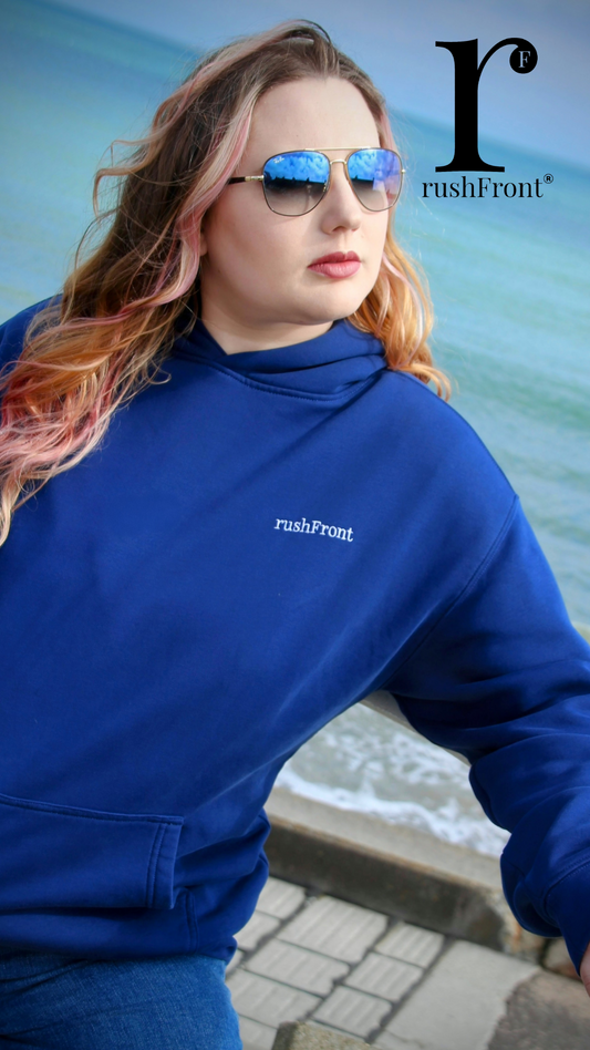 Person wearing a blue sweatshirt with 'rushFront' logo against a water background