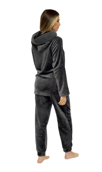 Person wearing a gray hoodie and pants set on a white background