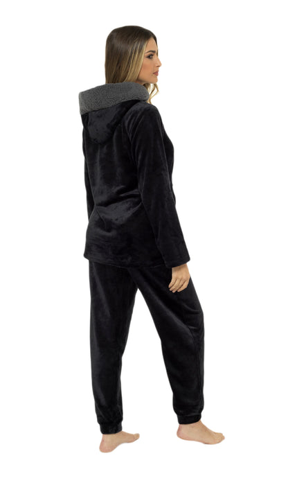 Person wearing a black fleece hoodie and pants on a white background
